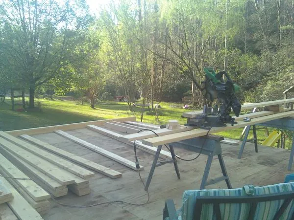 Miter saw and framing lumber on a deck under construction in Lorane
